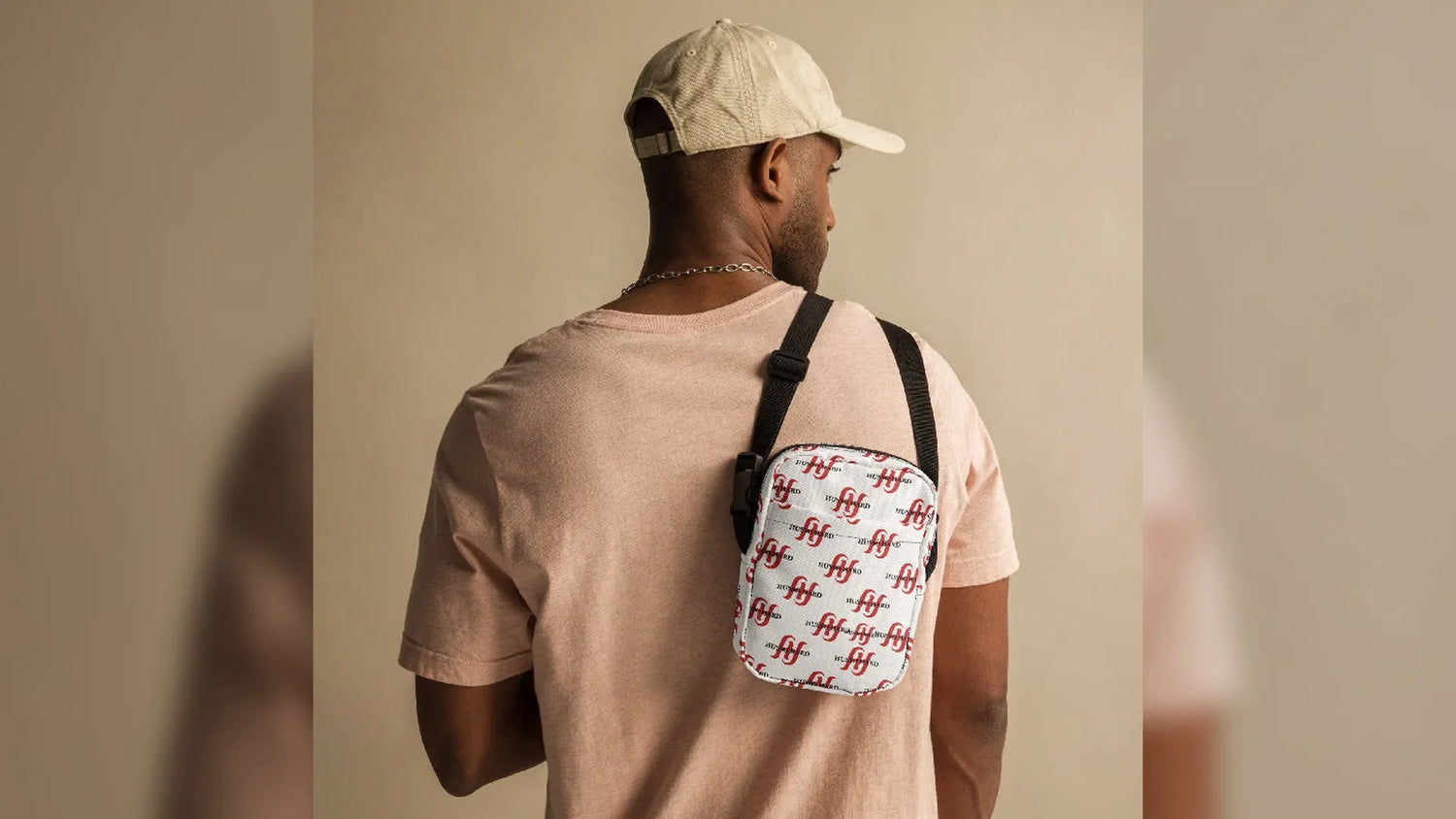 Man wearing white Husso Hard logo crossbody bag from back view