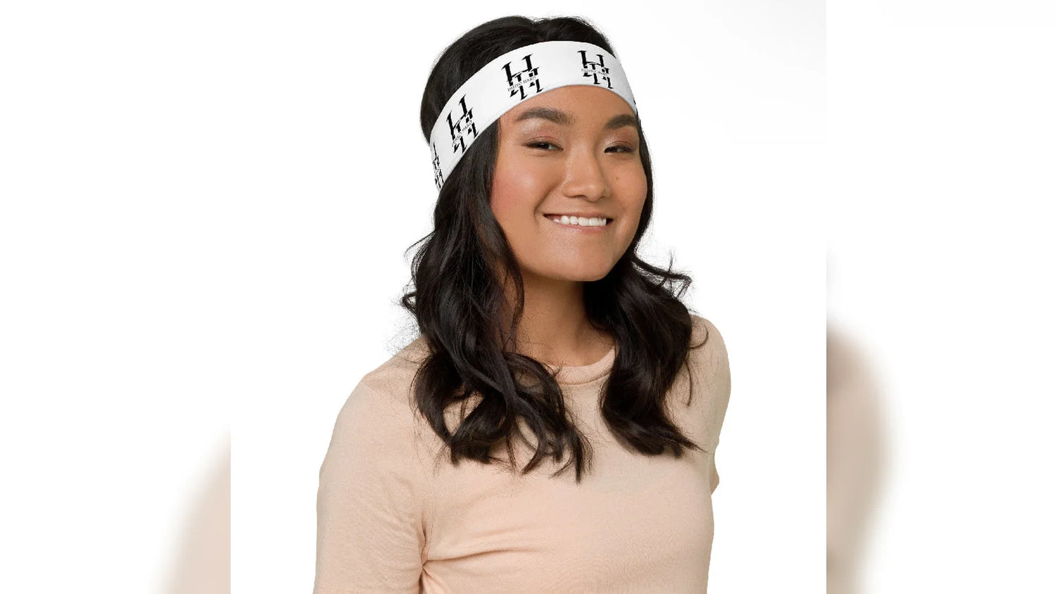 Woman wearing white Husso Hard logo headband for hair accessories collection
