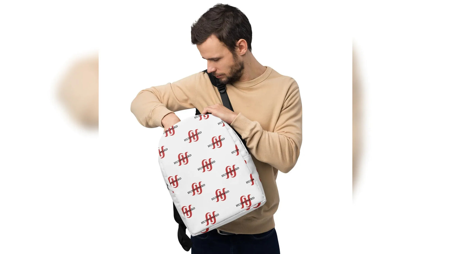 Man wearing white Husso Hard logo minimalist backpack with beige sweatshirt