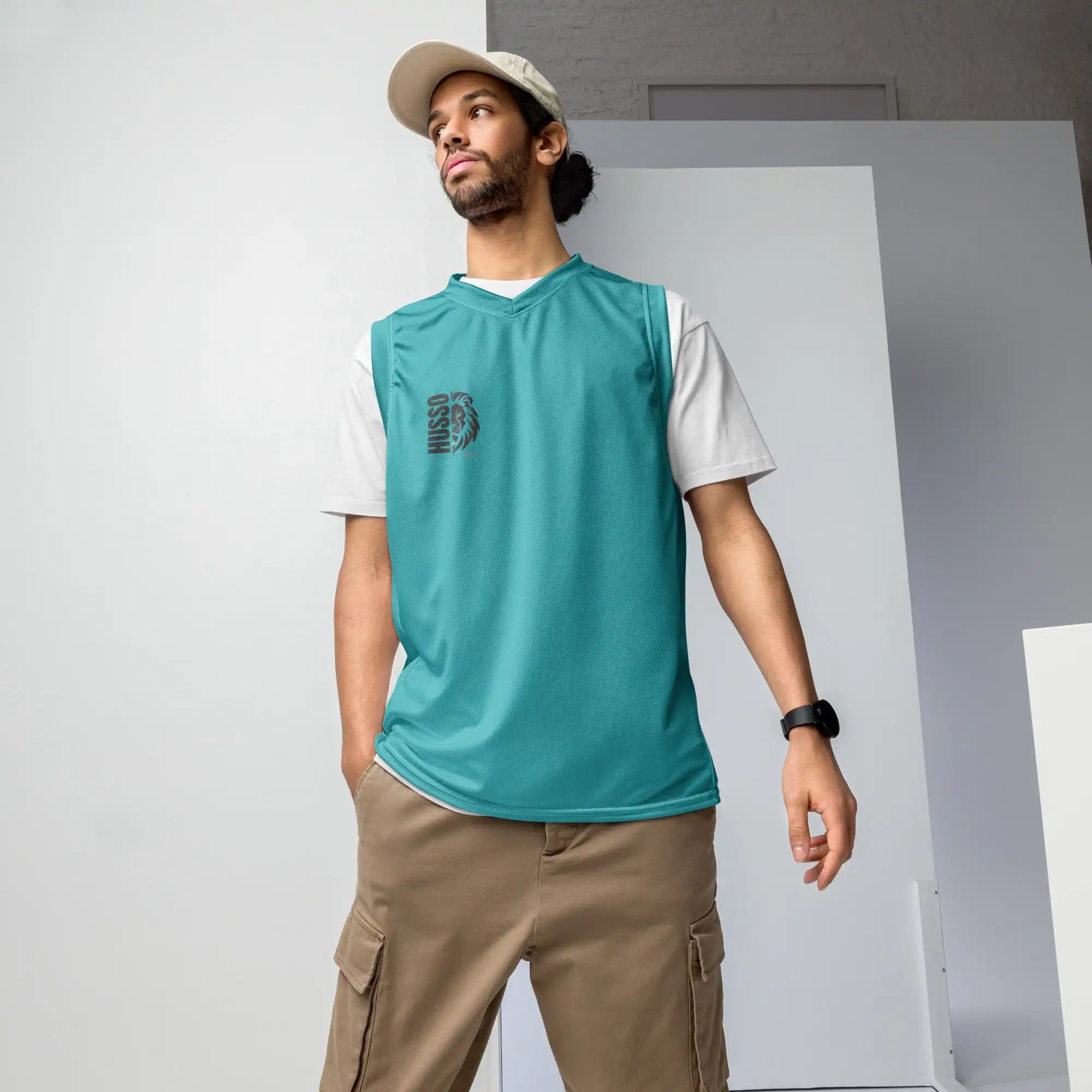Man wearing teal Husso Hard sleeveless jersey over white t-shirt with beige cargo pants