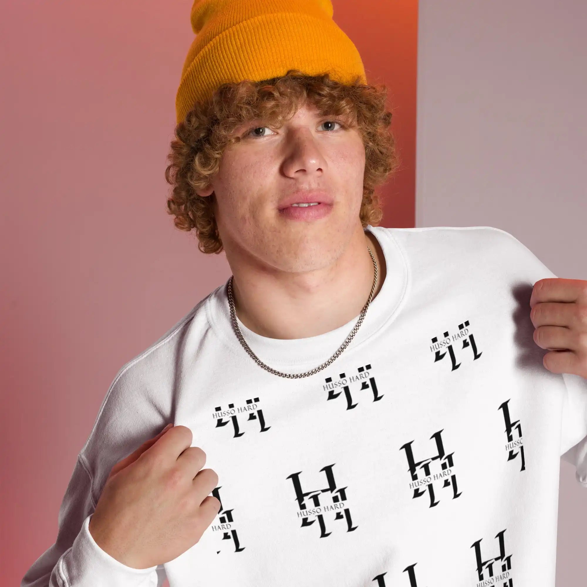Man wearing white Husso Hard all-over print sweatshirt with yellow beanie