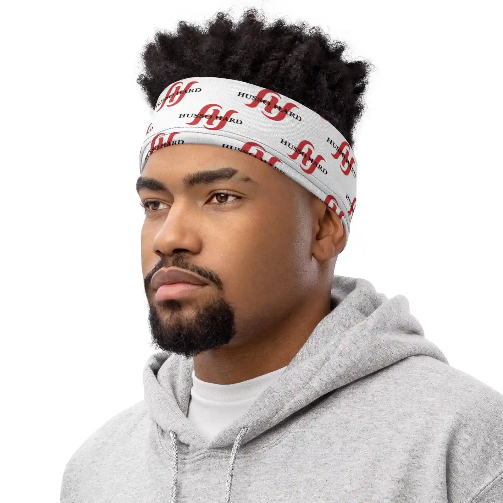 Man wearing white Husso Hard logo headband with grey hoodie