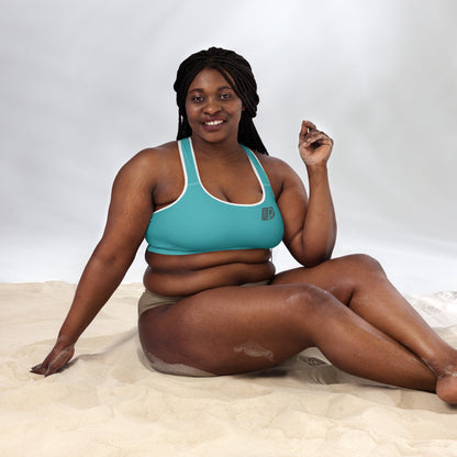 Woman wearing blue Husso Hard padded sports bra, seated view